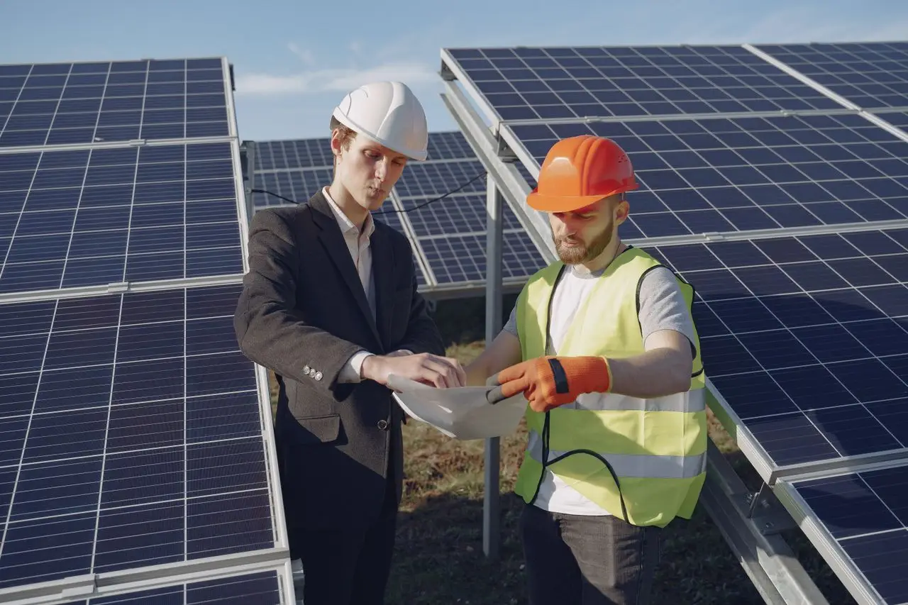 A surveyor examining a house roof with a clipboard during a solar assessment